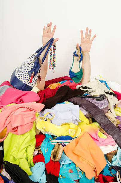 istock Man hands reaching out from a big pile of clothes. 499598155