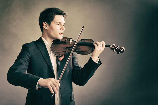istock Man violinist playing violin. Classical music art 499598275