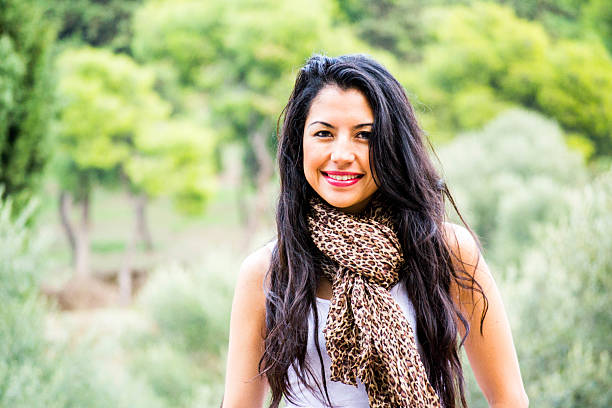 istock Young woman smiling with green background 499599145