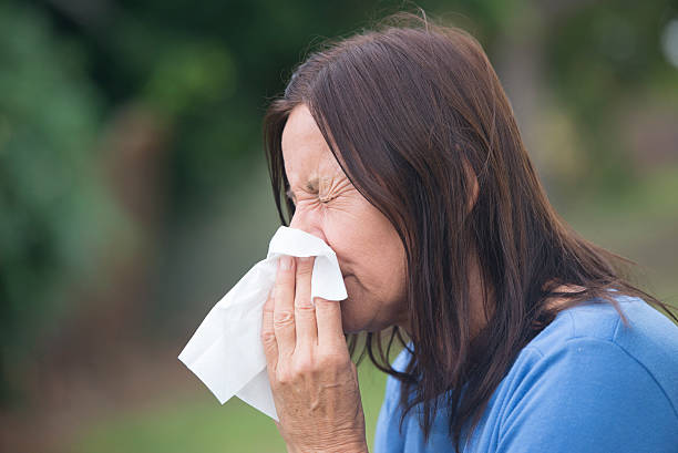 istock Woman suffering flu sneezing in tissue 499599354