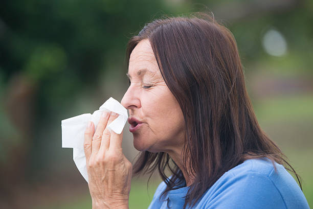 istock Woman with tissue suffering flu or hayfever 499599482