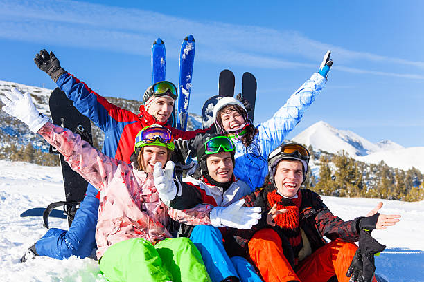 istock Positive friends with snowboards lifting hands up 499600655