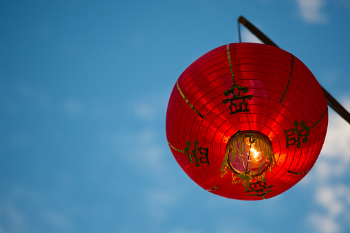 Red chinese paper lanterns hanging on a evening blue sky