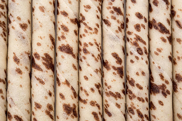 istock Close-up of striped wafer rolls. Background or texture 499600822