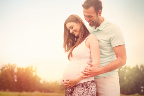 Portrait of lovely future parents during sunset 