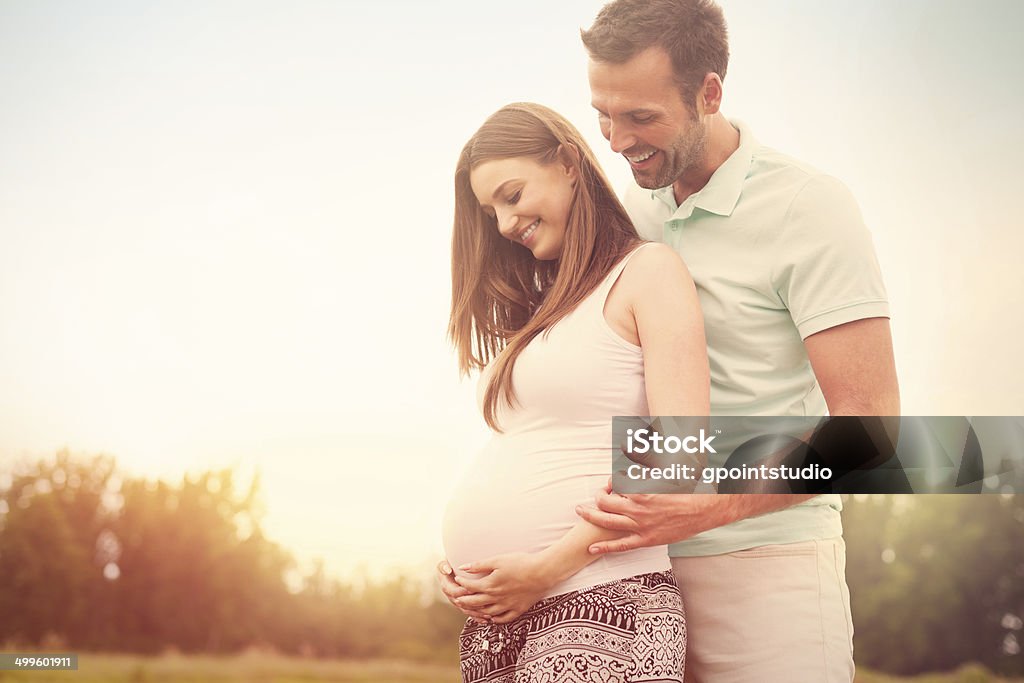 Portrait of lovely future parents during sunset Portrait of lovely future parents during sunset  Pregnant Stock Photo