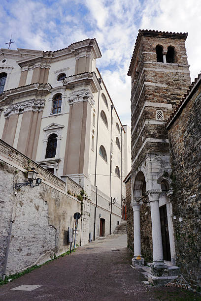 istock Old street in Trieste, with Saint Justus Cathedral 499602986