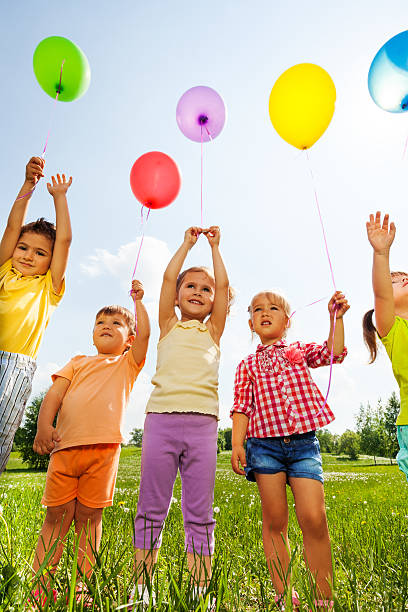 istock Funny kids with balloons in the air 499603079