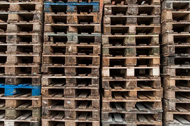 A lot of wooden pallet stacked in a corner of an german harbour.