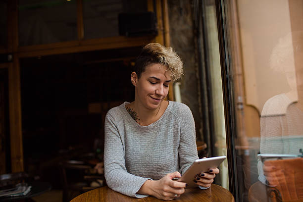 istock Young woman reading at  tablet 499604156