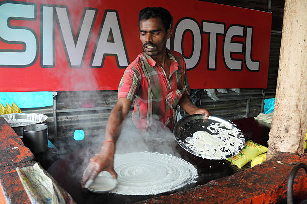 Munnar, Kerala,India - March 2, 2015: Chef Making Dosa at a restaurant at Munnar, Keral, India