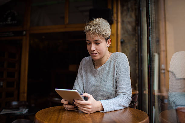 istock Young woman reading at  tablet 499604736