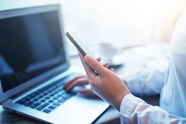 istock Businesswomen using mobile phone and laptop in office 499604842