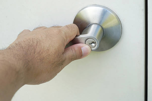 istock left man hand on silver knob door 499607468