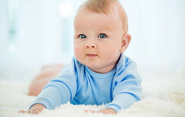 istock Cute toddler lying in bed and looking at camera. 499607640