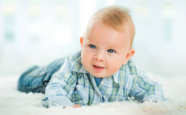 istock Baby by lying on blanket and looking away. 499607732