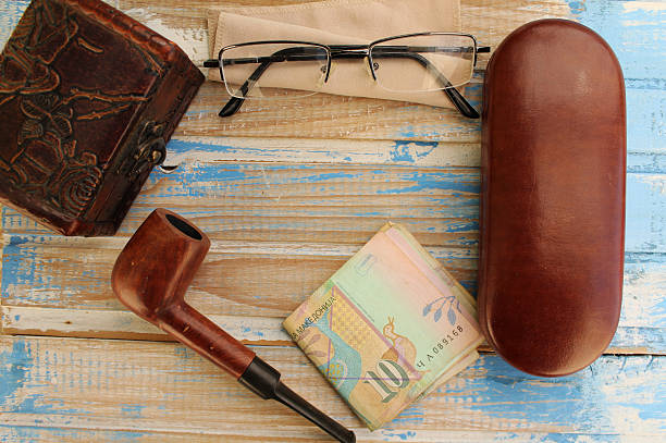 Smoking pipe, eyeglasses case, eyeglasses, money and box - copy space