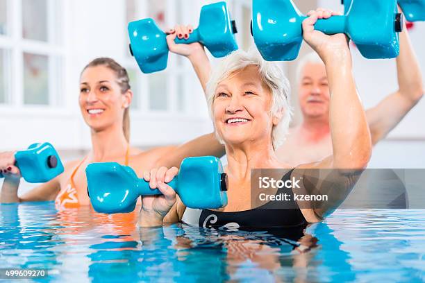 People At Water Gymnastics In Physiotherapy Stock Photo - Download Image Now - Water Aerobics, Exercising, Swimming Pool