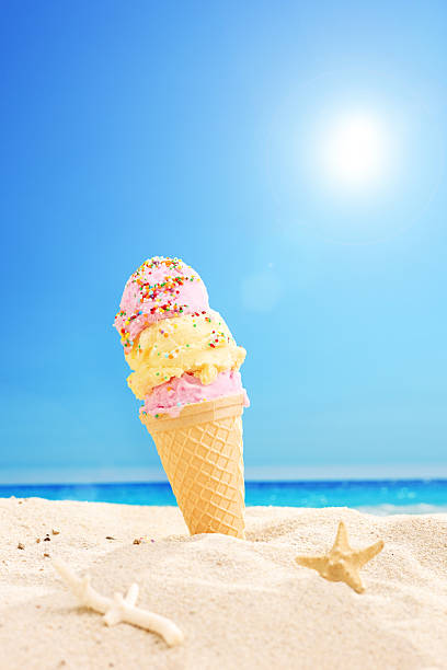 istock Ice cream stuck in sand on a sunny tropical beach 499615077