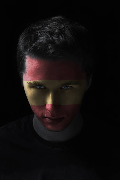 istock serios man face with painted flag colors of Spain 499615265