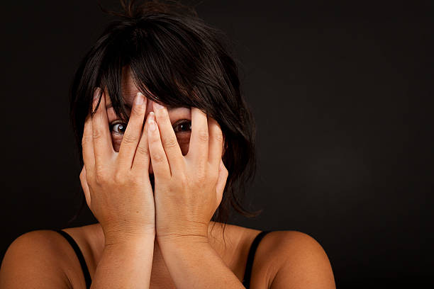istock Woman holding hands in front of face 499615369