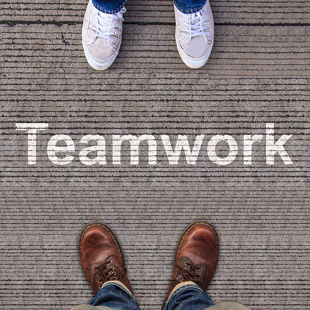 istock Pair of shoes standing on walkway with arrow 499615567