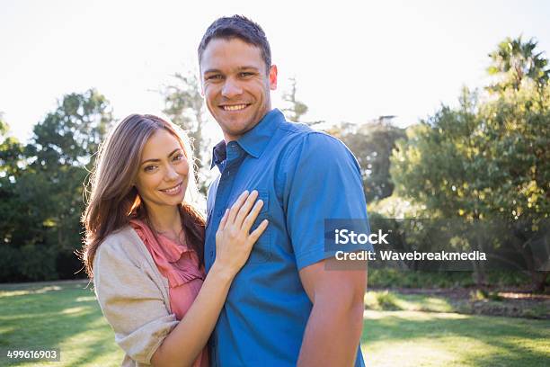 Smiling Couple Standing In A Park Stock Photo - Download Image Now - 30-39 Years, Adult, Beautiful People