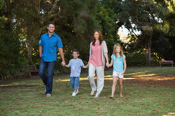 istock Parents walking with their two children 499617131