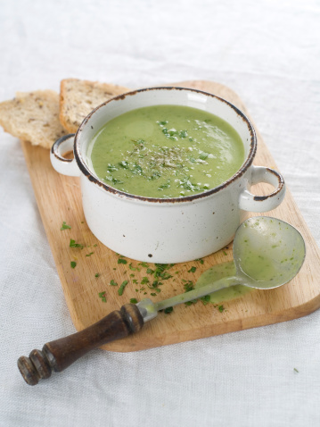 Delicious vegetable cream soup with broccoli and parsley, selective focus