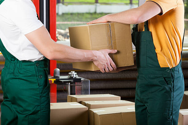 istock Close-up of warehouse workers with box 499617981
