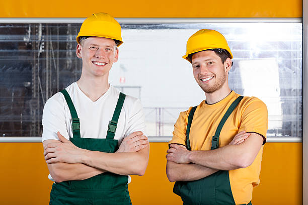 istock Workers in protective workwear standing with arms crossed 499618129