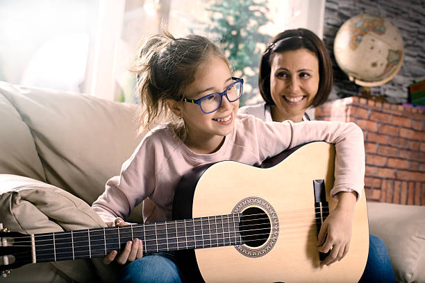 istock Girl playing guitar 499618616