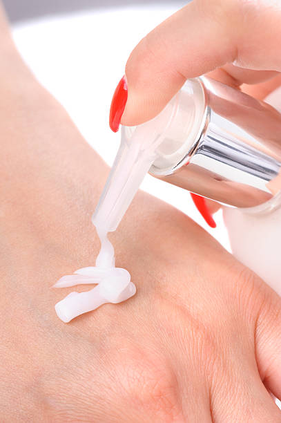 istock hands skin care - cream applying 499619685
