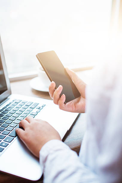 istock Businesswomen using mobile phone and laptop in office 499619962