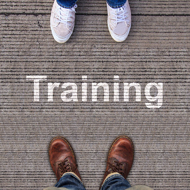 istock Pair of shoes standing on walkway with arrow 499620361
