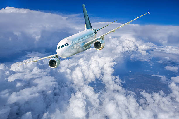 istock Aircraft in the blue sky above white clouds 499620552