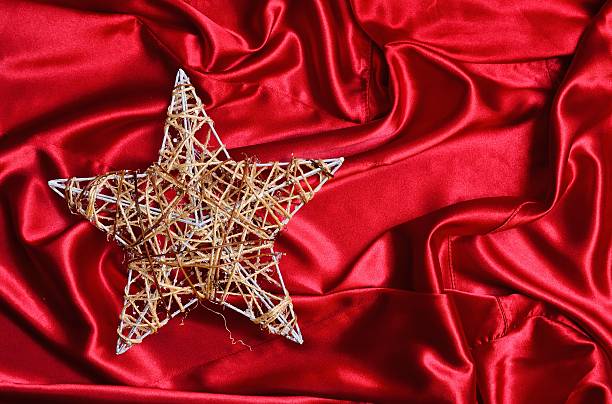 istock Christmas tree star on red satin 499620790