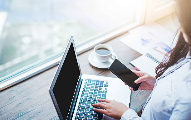 istock Businesswomen using mobile phone and laptop in office 499620862
