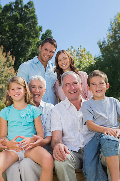 istock Cheerful multi generation family sitting on a bench in park 499621003