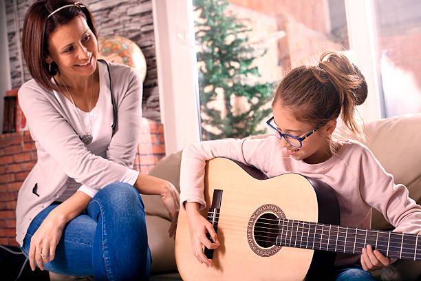 istock Girl playing guitar 499621304