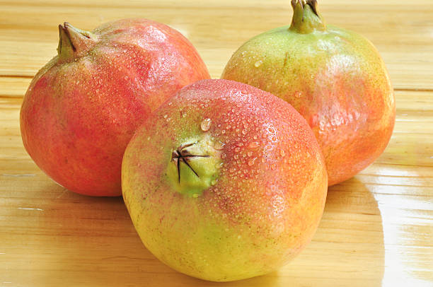 istock Pomegranate. Ripe pomegranates on wooden vintage background. 499622018