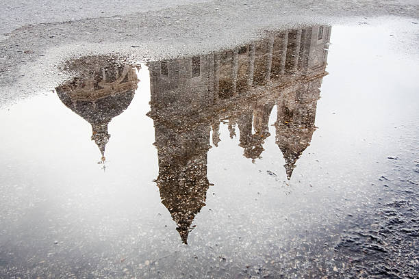 istock Almudena cathedral reflection on a street puddle, Madrid, Spain. 499622300