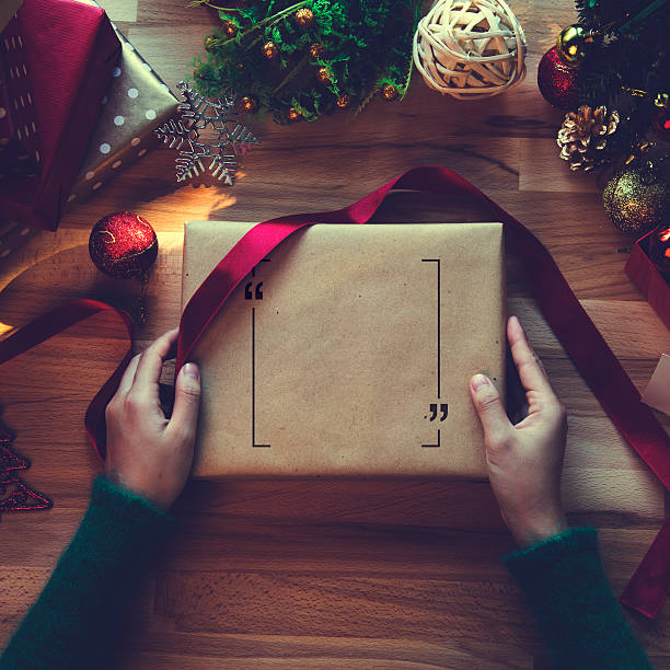 Overhead shot of Christmas presents and wrapping papers Overhead shot of Christmas presents and wrapping papers wrapping paper photos stock pictures, royalty-free photos & images