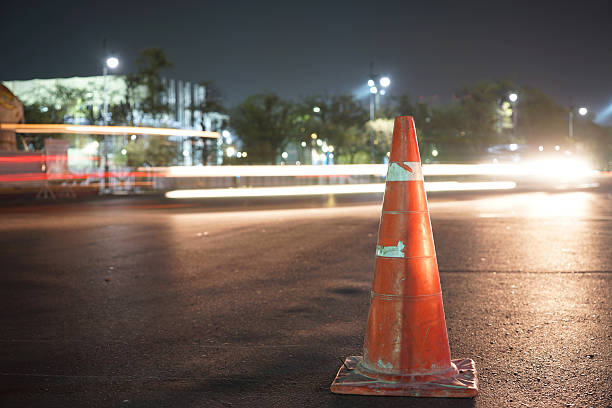 istock traffic cone on night cityscape 499625968