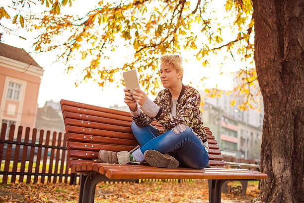 istock Young woman reading at tablet 499626528