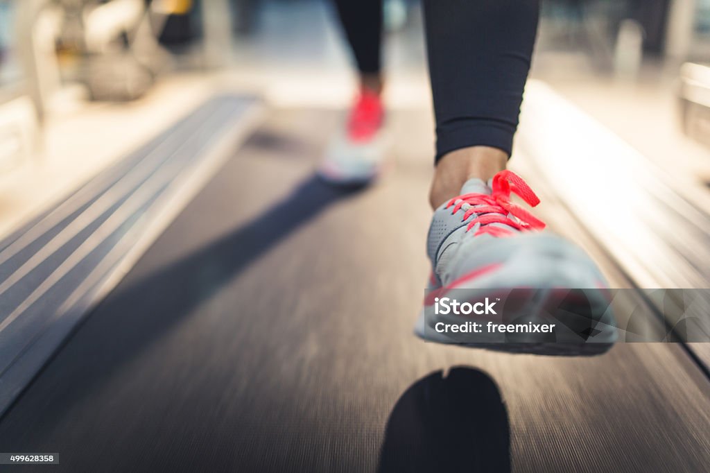 Close-up of Athlete shoes while running on treadmill Woman running on treadmill, close up on shoes Treadmill Stock Photo