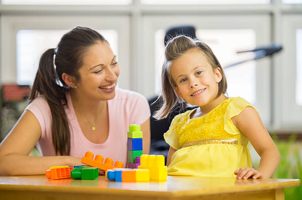 istock Caregiver Playing with a Special Needs Child 499628374