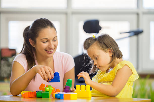 istock Special Needs Child Building Playing with Toys 499628420