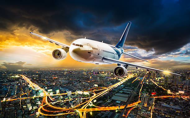 istock Airplane over night scene city 499629486