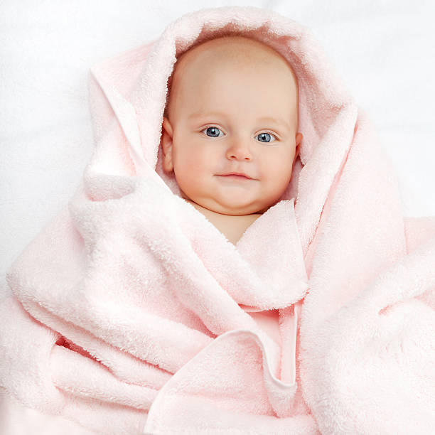 istock Caucasian baby boy covered with pink towel 499631898